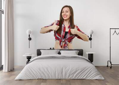 Strong young handyman woman in plaid top shirt, denim shorts, kit tools belt full of variety useful instruments isolated on white background. Female doing male work. Renovation and occupation concept. Wall mural