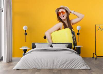 traveler tourist woman in summer casual clothes, hat with suitcase isolated on yellow orange backgro Wall mural