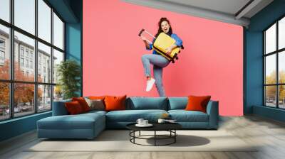 Traveler woman wears blue shirt casual clothes hold suitcase pov play guitar isolated on plain pink background. Tourist travel abroad in free spare time rest getaway. Air flight trip journey concept. Wall mural