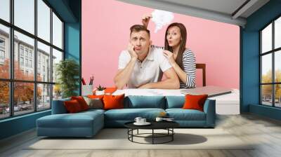 Two fun business woman man colleagues sit work at white desk with idea lightbulb cloud, laptop isolated on pastel pink background. Achievement career concept. Copy space advertising, youth co working. Wall mural