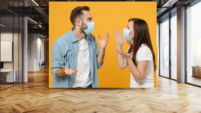 Two people in sterile face masks white t-shirts isolated on yellow background studio. Epidemic pandemic rapidly spreading coronavirus 2019-ncov medicine flu virus ill sick disease treatment concept. Wall mural