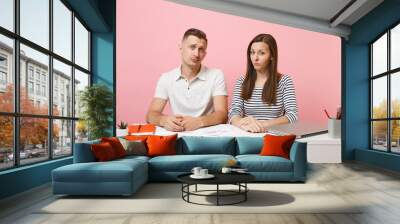 Two young upset business woman man colleagues sit work at white desk with contemporary laptop isolated on pastel pink background. Achievement career concept. Copy space advertising, youth co working. Wall mural