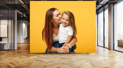 Woman in light clothes have fun with cute child baby girl 4-5 years old. Mommy little kid daughter isolated on yellow background studio portrait. Mother's Day love family parenthood childhood concept. Wall mural