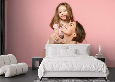 Woman in light clothes have fun with cute child baby girl. Mother, little kid daughter isolated on pastel pink wall background, studio portrait. Mother's Day, love family, parenthood childhood concept Wall mural