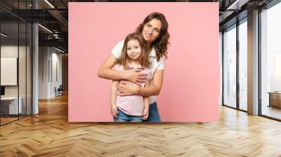 Woman in light clothes have fun with cute child baby girl. Mother, little kid daughter isolated on pastel pink wall background, studio portrait. Mother's Day, love family, parenthood childhood concept Wall mural