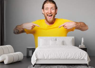 Young excited happy cheerful cool Caucasian man he wears yellow t-shirt casual clothes point index finger on himself look camera isolated on plain grey background studio portrait. Lifestyle concept. Wall mural