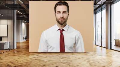 Young serious caucasian confident successful employee business man corporate lawyer 20s wear classic formal white shirt red tie work in office isolated on plain beige color background studio portrait Wall mural