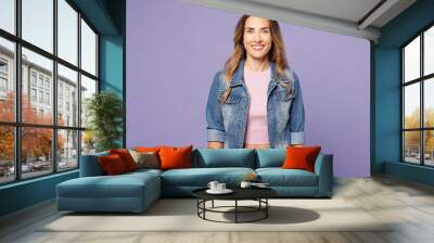 Young smiling happy cheerful fun cool satisfied woman she wear denim jacket violet top casual clothes look camera isolated on plain pastel light purple background studio portrait. Lifestyle concept. Wall mural