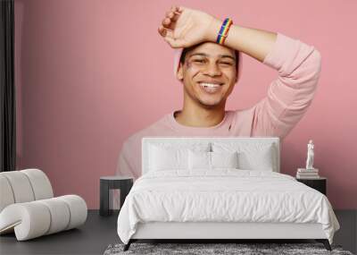 Young smiling happy fun cheerful gay man wear sweatshirt hat put hand on head forehead look camera isolated on plain pastel light pink color background studio portrait. Lifestyle lgbtq pride concept. Wall mural