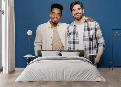 Young two friends smiling happy fun cool cheerful men 20s wear white casual shirts together looking camera put hand on shoulder isolated plain dark royal navy blue background People lifestyle concept Wall mural