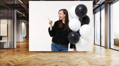 Young woman girl posing celebrating holding black and white air balloons isolated on white wall background studio portrait. Birthday holiday party people emotions lifestyle concept. Mock up copy space Wall mural