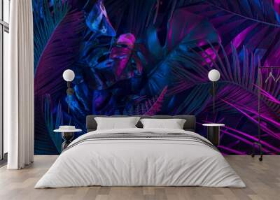 Trendy composition made of fluorescent color layout made of tropical jungle leaves. Flat lay neon colors. Nature concept. Creative art, minimal aesthetics. Wall mural