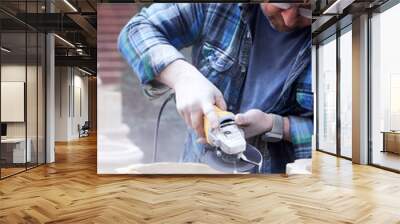 a male construction worker sawing stone  Wall mural