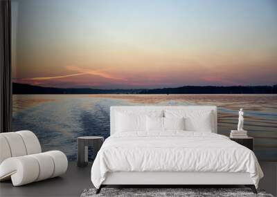 view of a wave on the river from a boat on a pink summer evening sunset Wall mural