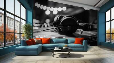 DJ headphones on a vinyl player in a dark nightclub, selective focus Wall mural