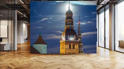 Majestic mediaval church towers of Riga in moonlight at night time. Dome cathedral and St. Peter's church backlit by the moon. Historical architecture of Riga.  Wall mural