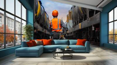 back view service worker with freight train oil transport on background. Wall mural