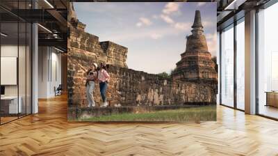 buddha statue in temple si sanphet. Couple woman travel in Historical Park Ayutthaya ,Thailand Wall mural