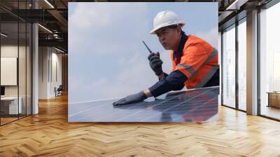 Solar cells have been maintained and maintenance by a team of engineers.  two engineers checking solar cells on power plant background.  Wall mural