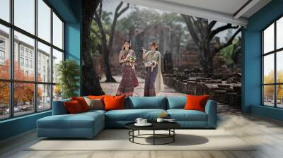 two women in traditional clothes. Beauty fantasy Thai women. Beautiful Thai girl in traditional dress costume ,Ayutthaya, Thailand. Asian women wearing traditional Thai culture, vintage style, Thai.  Wall mural