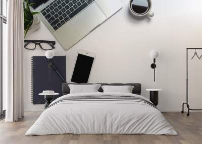 White office desk table with laptop, and smartphone and pen on a notebook with copy space, top view Wall mural