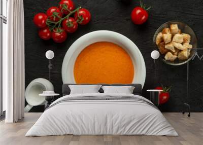 tomato cream soup in white bowl on black desk Wall mural