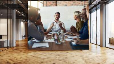 Getting into the details. Cropped shot of a mature businessman leading a meeting in the boardroom. Wall mural