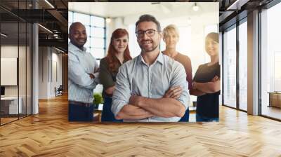 Happy businessman, portrait and arms crossed in leadership, management or CEO team at the office. Confident business people or professional standing with smile for teamwork or about us at workplace Wall mural