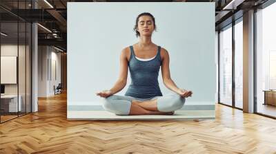 Mindfulness, meditation and woman do yoga for wellness, breathing exercise and healthy body in studio. Mindset, spiritual zen and calm female person meditate for wellbeing, peace and holistic balance Wall mural