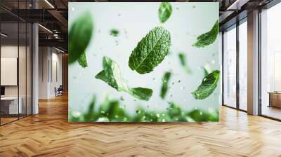 A bunch of green leaves suspended in mid-air, creating a beautiful and dynamic display Wall mural