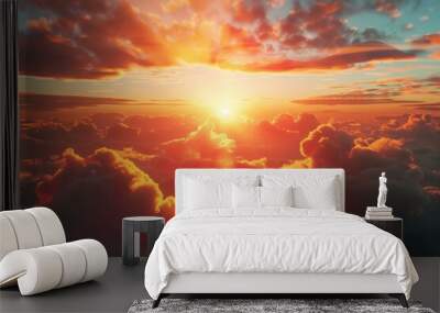 A picture of the sunset over clouds in the sky, great for use as a background or wallpaper Wall mural