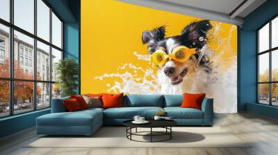 A playful dog in goggles splashing around on a bright yellow background, suitable for illustration or design Wall mural