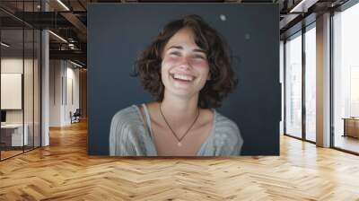 A smiling woman wearing a necklace, a symbol of happiness and joy Wall mural