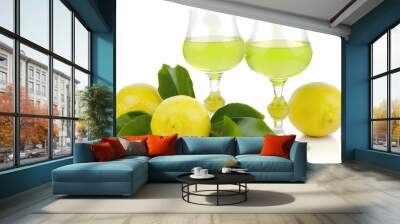 Freshly squeezed lemonade with two glasses and a bowl of lemons on a wooden table Wall mural