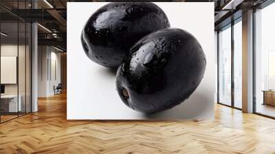 Two black olives placed on a white surface, great for use in food or still life photography Wall mural