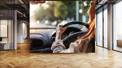 Woman driving a car on a busy city street Wall mural