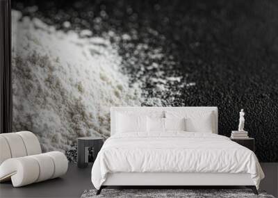 An isolated pile of flour isolated on a black background - Macro shot of baking ingredients Wall mural