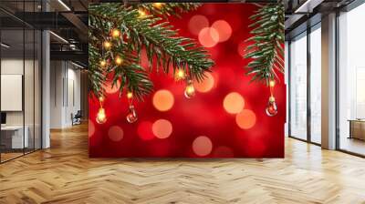 During the holiday season, a close-up view of a pine tree branch with decorative lights can be seen. Wall mural