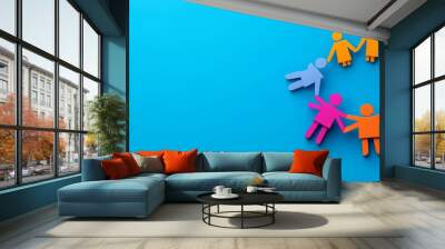 Paper cut-out figures hold hands in a circle over a blue background in a colorful arrangement. Wall mural