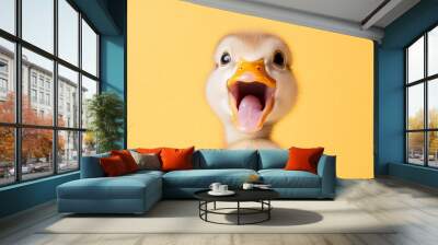 The cute surprised face of a baby chicken on a yellow background is a realistic stock image Wall mural