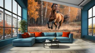 There is a brown horse running through tall grass and autumn foliage. Wall mural