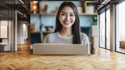 Portrait of a smiling asian woman with boxes. Wall mural