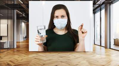 Ill woman checking pill having fever. Girl in protective mask, having cold, flu. quarantine, corona virus, isolated Wall mural