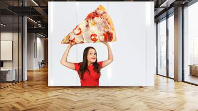 Young hunger pretty funny woman holds huge and large piece of pizza with cheese, Girl walks with big heavy pizza Wall mural