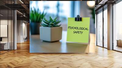 Sticky notes prominently displaying the phrase psychological safety arranged on a sleek, modern office desk Wall mural