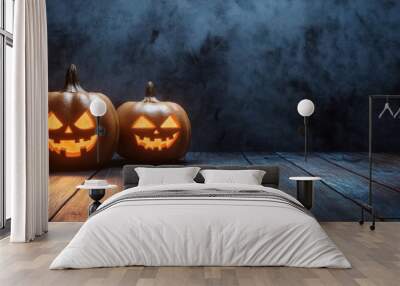 Three eerie Halloween pumpkins with carved faces stand on an aged wooden floor to the left, copi space Wall mural