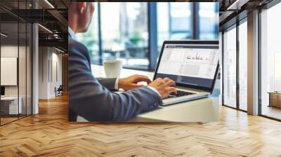 Focused businessman looking at laptop monitor, analyzing project statistics, marketing research results or statistics data, developing marketing strategy, working at office Wall mural