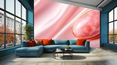  A close-up of a rose-tinted spoon with a pink liquid within, atop a velvety pink satin surface The golden handle gleams in contrast Wall mural