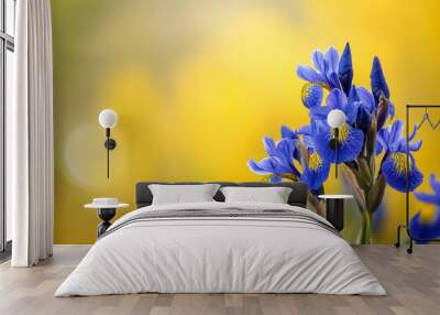  A field of blue flowers atop a verdant grass expanse, facing a sunlit yellow backdrop Wall mural