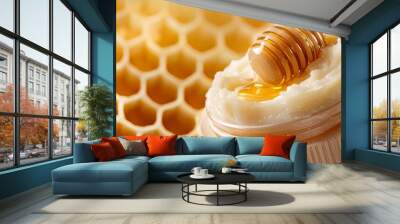  A jar of honey sits atop a wooden table, next to a honeycomb and unaltered honeycombs Wall mural